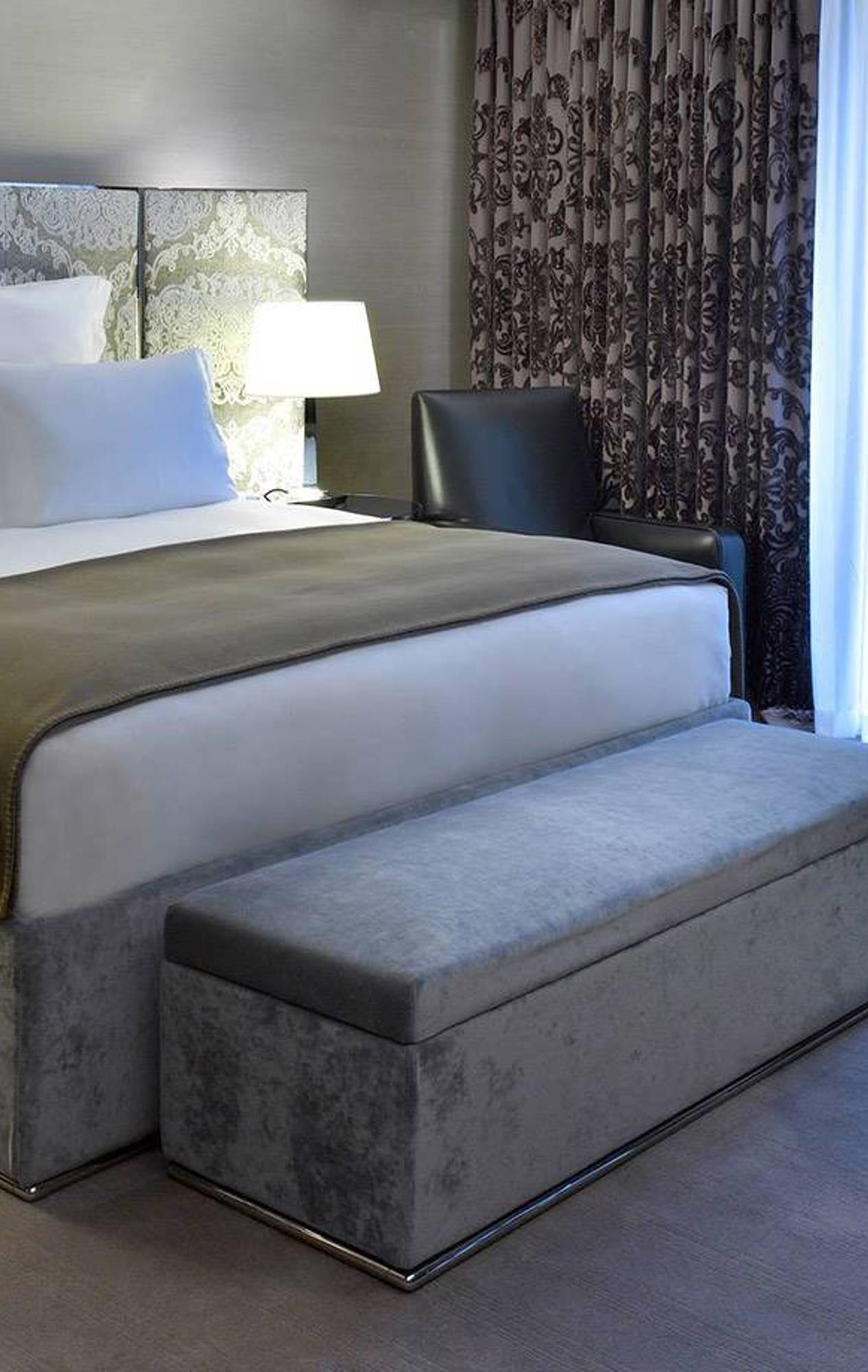 Elegant exterior of the Bulgari Hotel in London, showcasing a modern design with a facade of polished stone and glass.