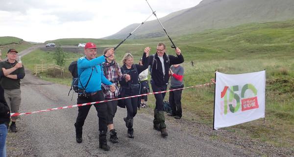 Colleagues crossing the finish line on Rannoch Moor trek