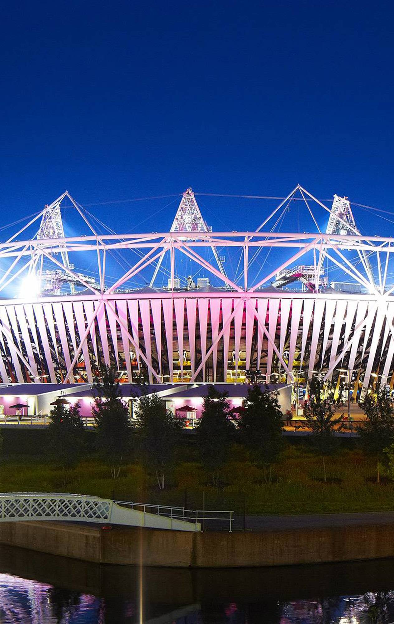 The Olympic Stadium illuminated at dusk, highlighting its architectural beauty and the energy-efficient lighting