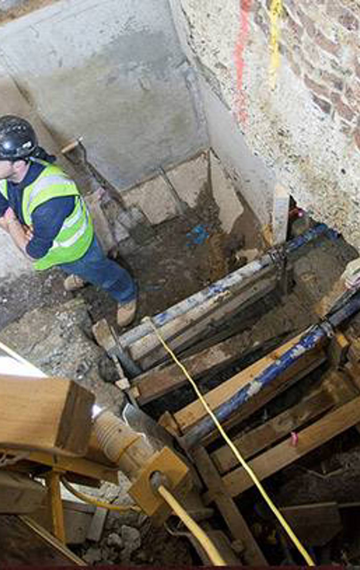 Construction workers extending the shaft downwards on the existing service lift at Royal Albert Hall